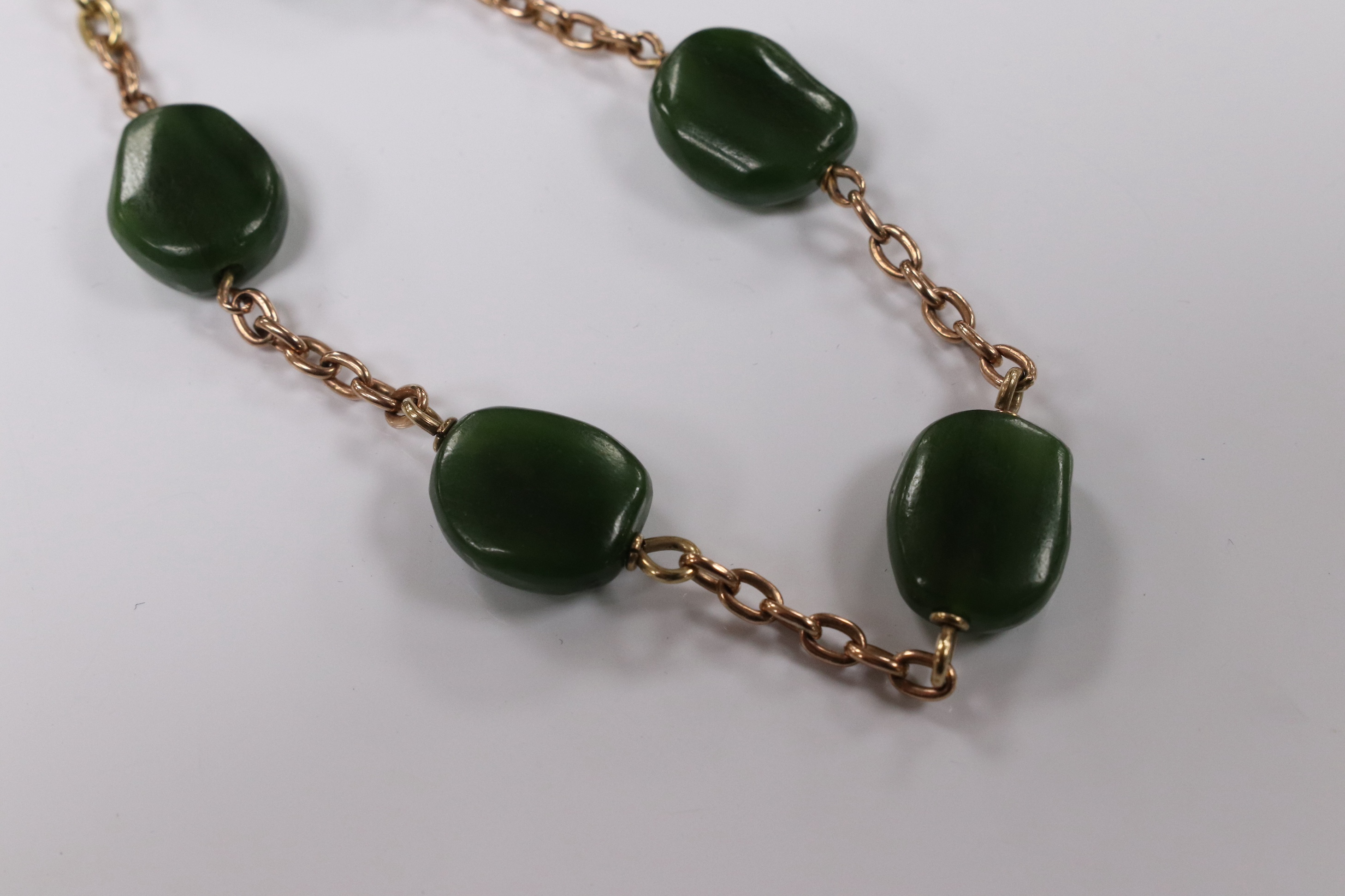 A 9ct and five stone jade bead set bracelet, 19cm, gross weight 15.2 grams. Condition - fair